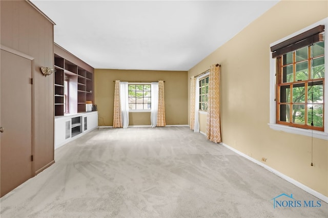 545 Wallace Ave, Bowling Green, OH 43402 - unfurnished living room featuring carpet and baseboards