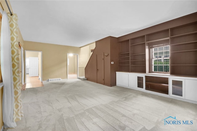 545 Wallace Ave, Bowling Green, OH 43402 - unfurnished living room with light colored carpet and built in shelves