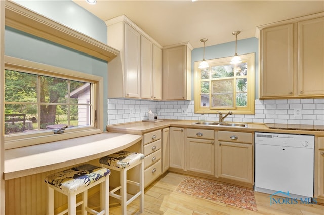 545 Wallace Ave, Bowling Green, OH 43402 - kitchen with white dishwasher, plenty of natural light, backsplash, and hanging light fixtures