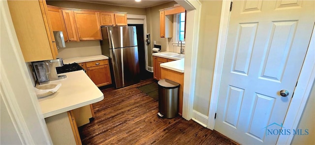 3329 Kirkwall Rd, Ottawa Hills, OH 43606 - kitchen with freestanding refrigerator, dark wood finished floors, light countertops, and range with gas stovetop