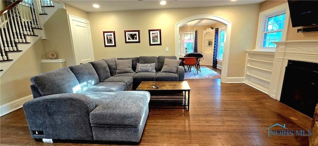 3329 Kirkwall Rd, Ottawa Hills, OH 43606 - living area featuring arched walkways, stairs, wood finished floors, recessed lighting, and built in features