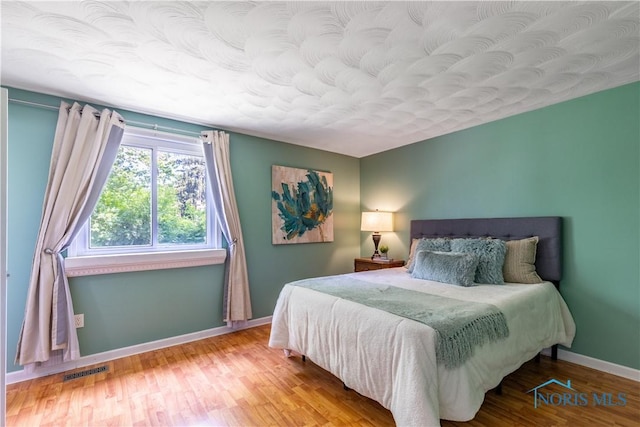 6768 Denbridge Dr, Sylvania, OH 43560 - bedroom featuring baseboards and wood finished floors