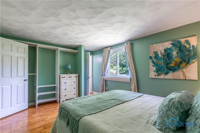 6768 Denbridge Dr, Sylvania, OH 43560 - bedroom featuring wood finished floors and a textured ceiling