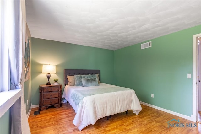 6768 Denbridge Dr, Sylvania, OH 43560 - bedroom with light wood-style floors and a textured ceiling