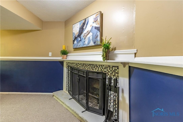 6768 Denbridge Dr, Sylvania, OH 43560 - detailed view of carpet, a tiled fireplace, and a textured ceiling