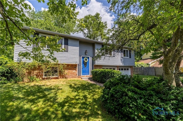 6768 Denbridge Dr, Sylvania, OH 43560 - raised ranch with an attached garage and brick siding