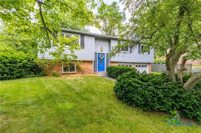 6768 Denbridge Dr, Sylvania, OH 43560 - split foyer home with an attached garage and brick siding