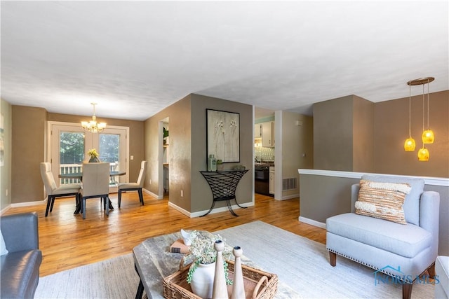 6768 Denbridge Dr, Sylvania, OH 43560 - living room with a chandelier and light wood-type flooring