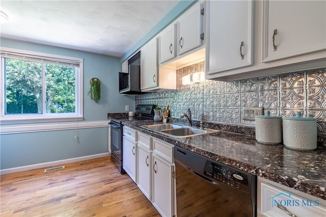 6768 Denbridge Dr, Sylvania, OH 43560 - kitchen featuring black appliances, decorative backsplash, light wood-style floors, white cabinetry, and dark stone countertops