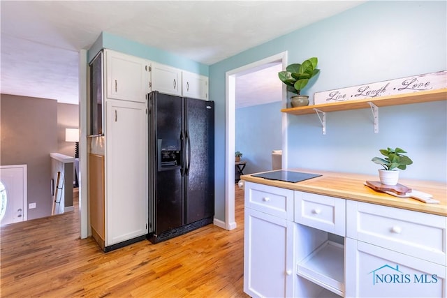 6768 Denbridge Dr, Sylvania, OH 43560 - kitchen featuring black refrigerator with ice dispenser, open shelves, white cabinetry, light wood finished floors, and light countertops