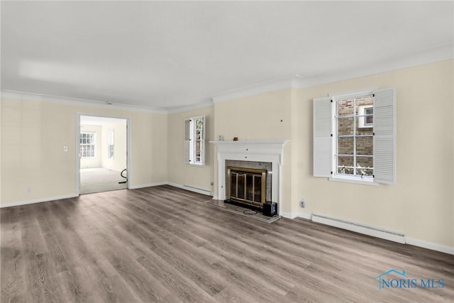 2310 Goddard Rd, Toledo, OH 43606 - unfurnished living room with a baseboard heating unit, wood finished floors, a high end fireplace, and ornamental molding