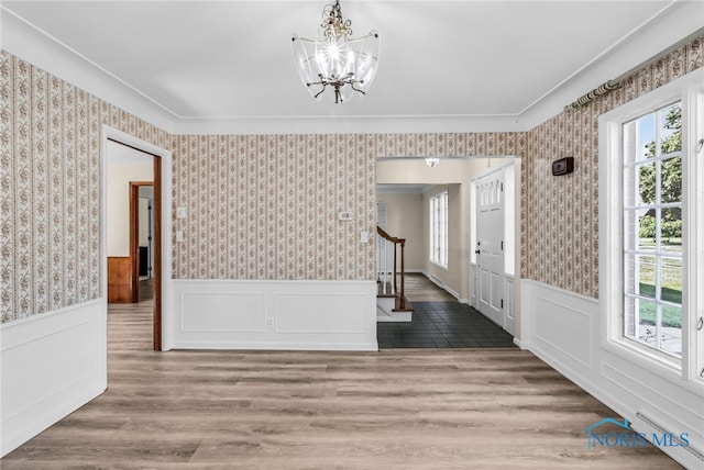2310 Goddard Rd, Toledo, OH 43606 - foyer featuring healthy amount of natural light, a chandelier, stairway, wainscoting, and a baseboard heating unit