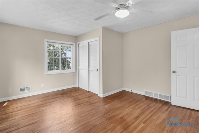 2310 Goddard Rd, Toledo, OH 43606 - unfurnished bedroom featuring wood finished floors, a closet, and ceiling fan