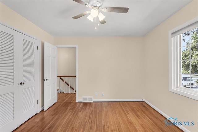 2310 Goddard Rd, Toledo, OH 43606 - unfurnished bedroom with light wood-type flooring, a closet, and a ceiling fan