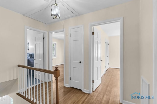 2310 Goddard Rd, Toledo, OH 43606 - hallway with attic access, wood finished floors, and an upstairs landing