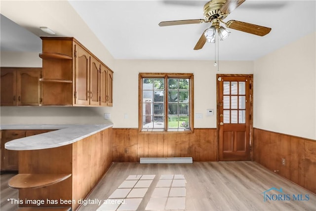 2310 Goddard Rd, Toledo, OH 43606 - kitchen featuring open shelves, a wainscoted wall, light countertops, light wood-style floors, and brown cabinets