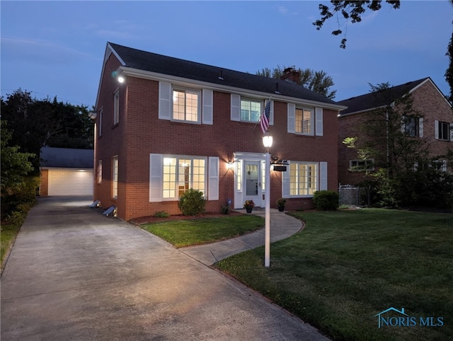 2310 Goddard Rd, Toledo, OH 43606 - colonial inspired home featuring an outdoor structure, brick siding, a chimney, and a front lawn