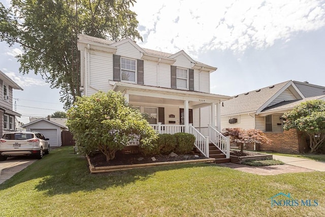 4334 Commonwealth Ave, Toledo, OH 43612 - view of front of home with covered porch, a front lawn, and a garage