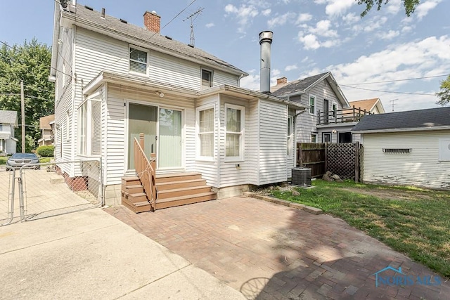 4334 Commonwealth Ave, Toledo, OH 43612 - rear view of property with entry steps, a patio area, and a chimney