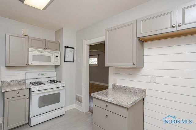 4334 Commonwealth Ave, Toledo, OH 43612 - kitchen featuring white appliances, gray cabinets, and light countertops