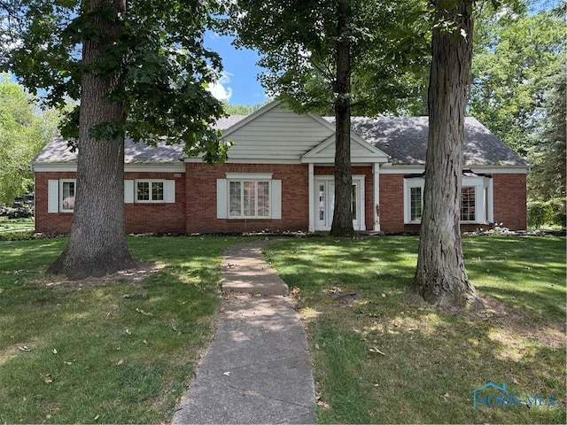 3228 Shakespeare Ln, Toledo, OH 43615 - view of front of house featuring brick siding and a front yard