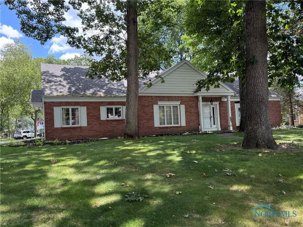 3228 Shakespeare Ln, Toledo, OH 43615 - view of front of house with a front lawn and brick siding