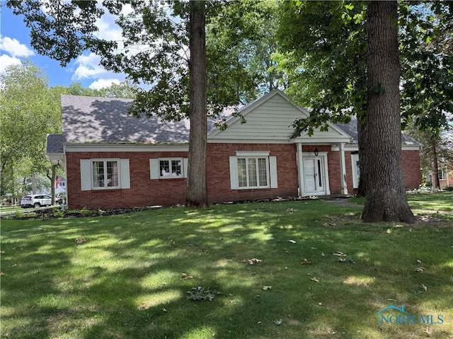 3228 Shakespeare Ln, Toledo, OH 43615 - view of front of house with a front lawn and brick siding