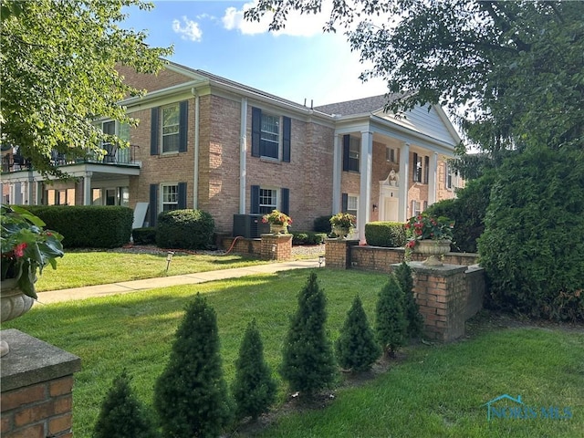 4243 W Bancroft St Unit 202W, Ottawa Hills, OH 43615 - neoclassical home featuring a front lawn and brick siding