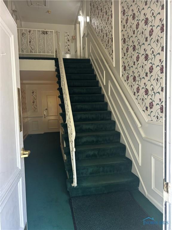 4243 W Bancroft St Unit 202W, Ottawa Hills, OH 43615 - stairs with carpet floors, a decorative wall, and wallpapered walls