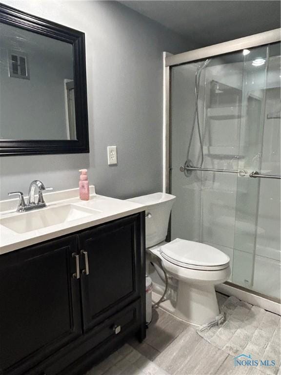 4243 W Bancroft St Unit 202W, Ottawa Hills, OH 43615 - bathroom featuring vanity, a stall shower, and wood finished floors