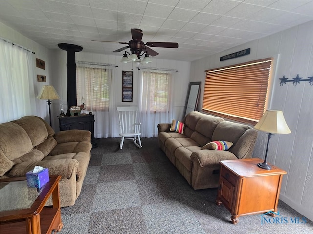 26654 Elliott Rd, Defiance, OH 43512 - carpeted living room featuring a wood stove and a ceiling fan