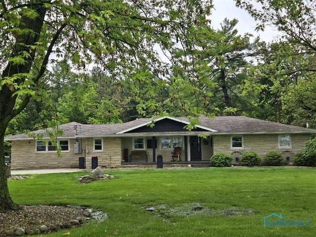 26654 Elliott Rd, Defiance, OH 43512 - ranch-style house with stone siding, covered porch, and a front lawn