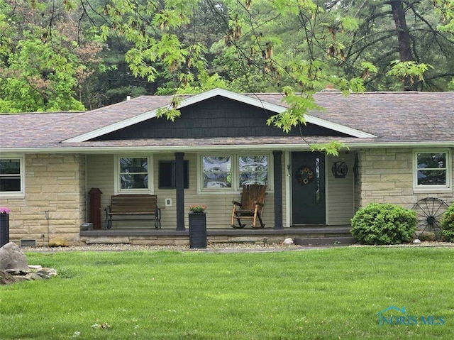 26654 Elliott Rd, Defiance, OH 43512 - view of front of property featuring stone siding, a front yard, roof with shingles, and covered porch