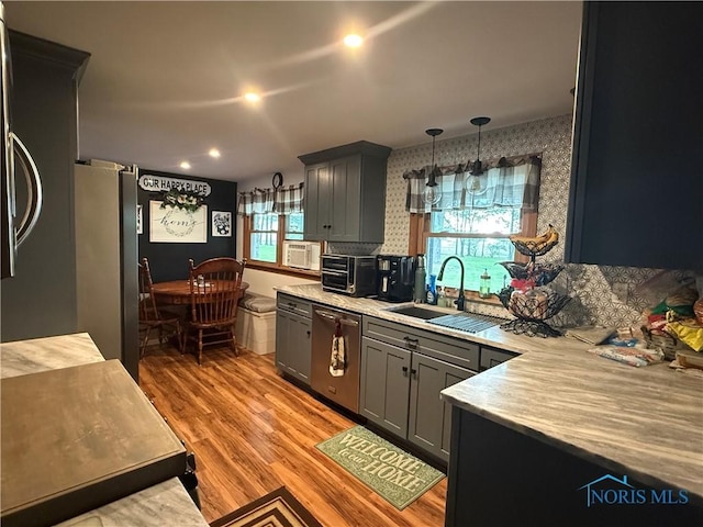 26654 Elliott Rd, Defiance, OH 43512 - kitchen with appliances with stainless steel finishes, light countertops, wallpapered walls, gray cabinetry, and light wood finished floors