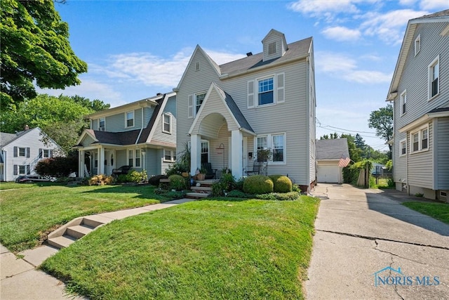 4526 Commonwealth Ave, Toledo, OH 43612 - view of front facade with a front yard and a garage