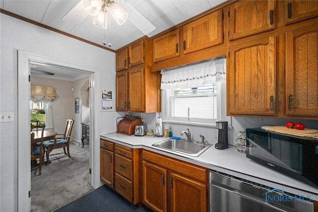 4526 Commonwealth Ave, Toledo, OH 43612 - kitchen with stainless steel dishwasher, ornamental molding, ceiling fan, light countertops, and carpet