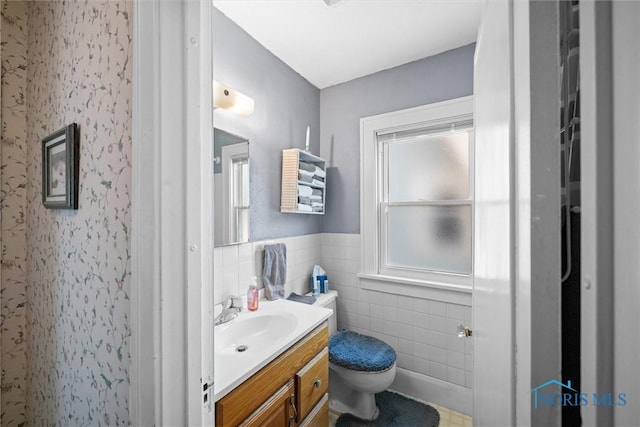 4526 Commonwealth Ave, Toledo, OH 43612 - bathroom featuring vanity, plenty of natural light, wainscoting, and tile walls