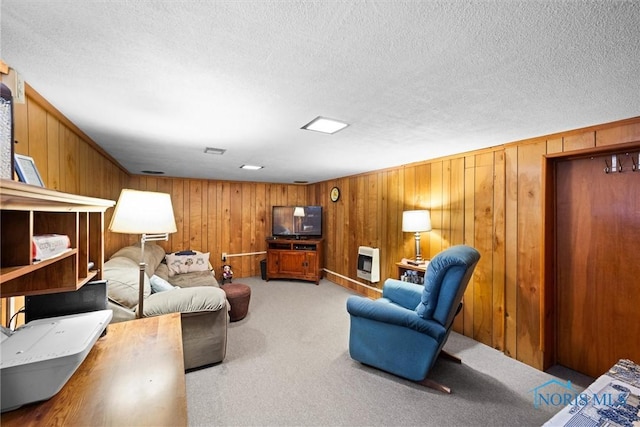 4526 Commonwealth Ave, Toledo, OH 43612 - carpeted living room with heating unit, a textured ceiling, and wood walls