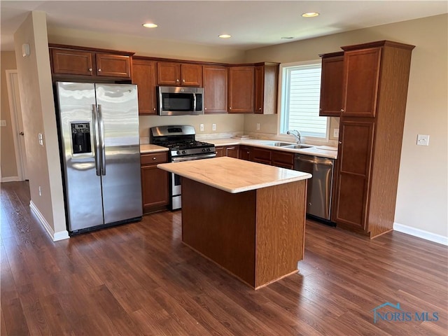813 Meadowchase Ln, Toledo, OH 43615 - kitchen with stainless steel appliances, dark wood-style flooring, light countertops, a center island, and recessed lighting