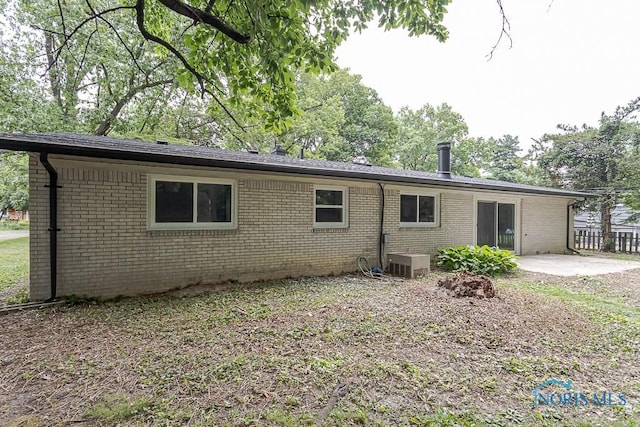 2617 Schroeder St, Toledo, OH 43613 - back of house featuring brick siding and a patio