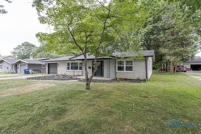 2617 Schroeder St, Toledo, OH 43613 - view of front of home featuring a garage, brick siding, and a front lawn