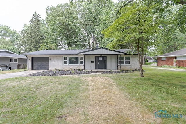 2617 Schroeder St, Toledo, OH 43613 - ranch-style home featuring an attached garage, concrete driveway, a front lawn, and brick siding