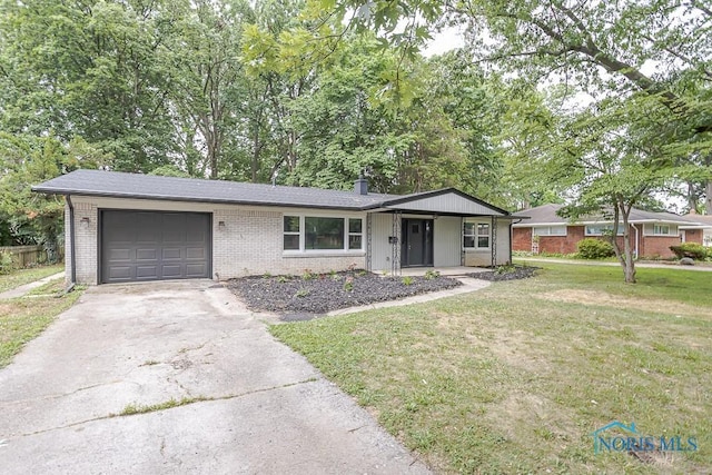 2617 Schroeder St, Toledo, OH 43613 - single story home with brick siding, driveway, an attached garage, a front lawn, and a chimney