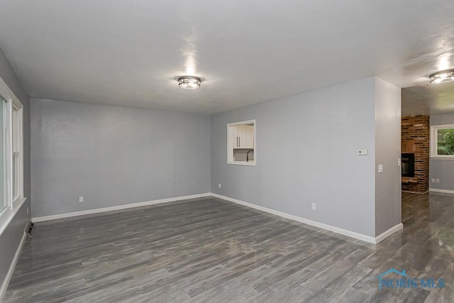2617 Schroeder St, Toledo, OH 43613 - empty room with dark wood finished floors and a fireplace