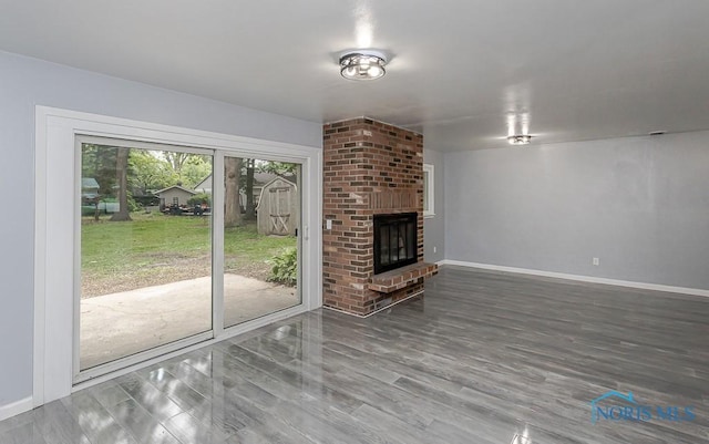 2617 Schroeder St, Toledo, OH 43613 - unfurnished living room featuring wood finished floors and a brick fireplace