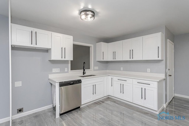 2617 Schroeder St, Toledo, OH 43613 - kitchen with dishwasher, light countertops, white cabinets, and light wood-style flooring