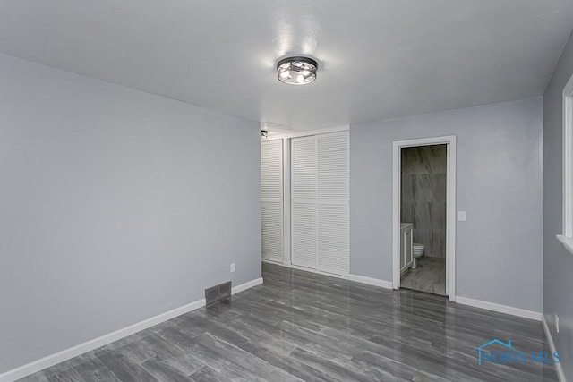 2617 Schroeder St, Toledo, OH 43613 - unfurnished bedroom featuring wood finished floors, a closet, and ensuite bathroom