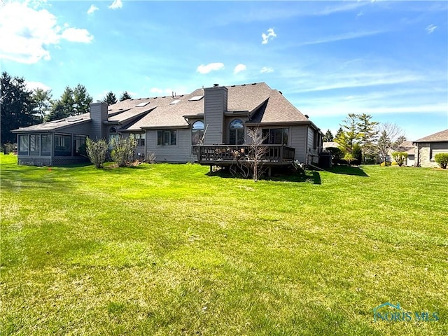 7361 Caracole Ct Unit 7361, Sylvania, OH 43560 - back of house featuring a deck, a lawn, and a chimney