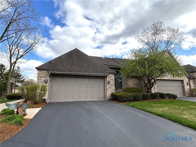 7361 Caracole Ct Unit 7361, Sylvania, OH 43560 - view of front of home featuring driveway, a garage, a shingled roof, and a front lawn