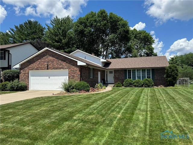 1240 Applegate St, Waterville, OH 43566 - ranch-style home featuring brick siding, a front yard, a garage, and driveway